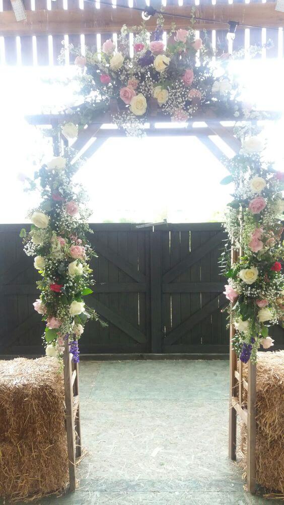 Pink wedding venue entrance archway flowers